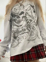 Womens Halloween shirt with skull print and off-shoulder style, paired with a plaid skirt.